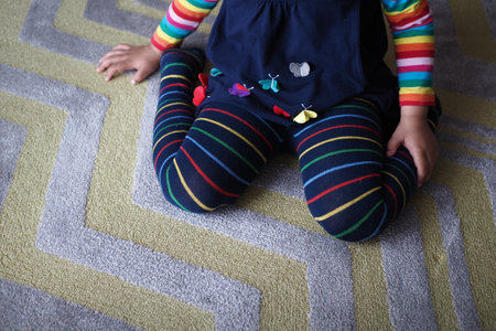 child sitting W posture on the floor .の写真素材