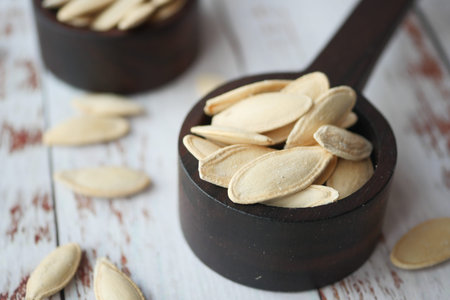 Dry Healthy organic Pumkin Seeds on wooden Spoon .の写真素材