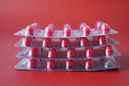 Close up of pills of blister pack red backgroundの写真素材