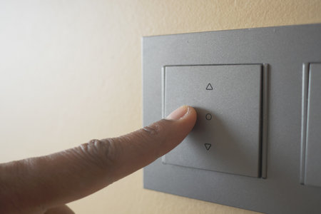 A finger turning on lighting switch .の写真素材