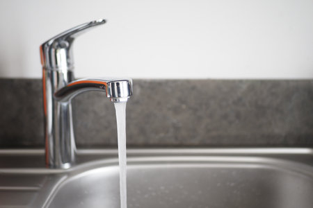 Water dripping from faucet tap at kitchen. Closeupの写真素材
