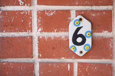 house number six. Decorative lettering on a brick wall.の写真素材