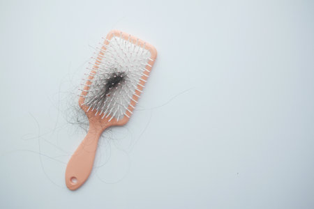 a brush with lost hair on tableの写真素材