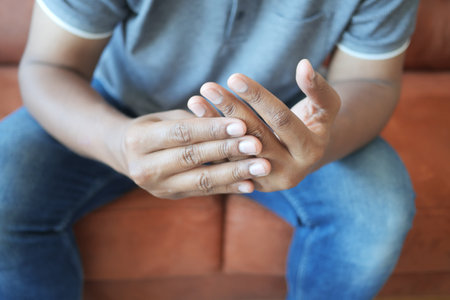 man suffering pain in hand close upの写真素材