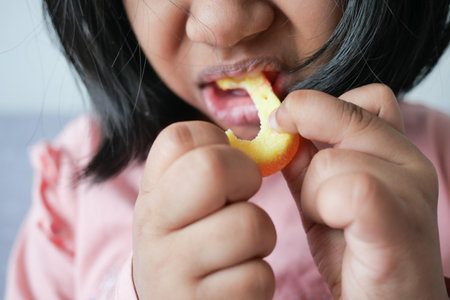 child mouth eating gummy candies closeupの写真素材