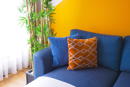 blue color modern sofa with pillows in living room at homeの写真素材