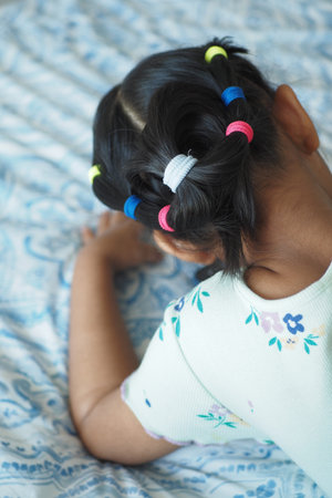 Beautiful ribbon is tied on a child hair