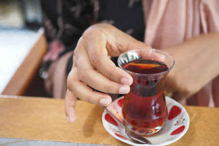 women drinking Traditional turkish tea on white table .の写真素材