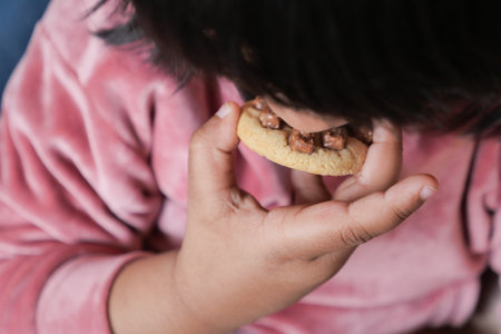 child mouth eating chocolate sweet cookiesの写真素材
