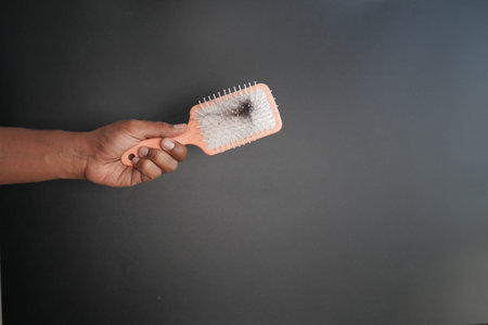 man hold his list hair close up