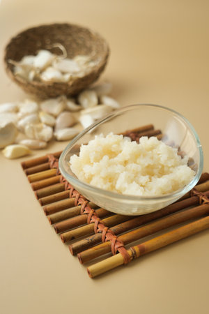 close up of minced garlic on a wooden spoonの写真素材