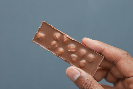holding a nut dark chocolateの写真素材