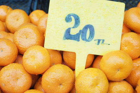 close up of slice of orange fruits with sales price bannerの写真素材