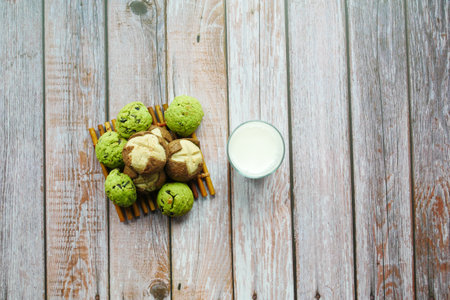 sweet cookies and glass of milk on tableの写真素材