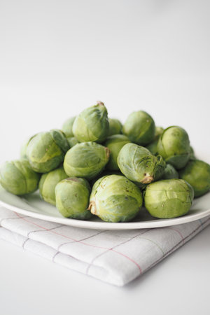 Fresh brussels sprouts in a box on a white backgroundの写真素材