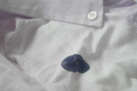 white shirt with blue ink stain .