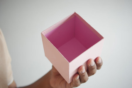 top view of person open a empty small gift box