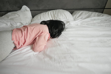 a upset child girl cover her face with hand