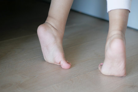 low angle view of A child walking on tiptoesの写真素材
