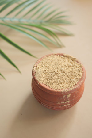 mixing brewers yeast flakes in a container on table