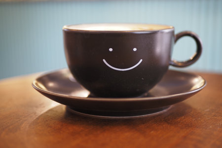 black coffee cup with smile shape design on itの写真素材