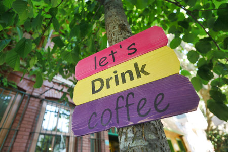 A sign at a coffee shop offering different types of coffee.の写真素材