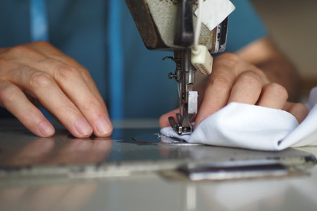 men hands using a sewing machine .の写真素材