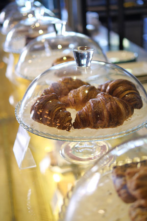 fresh baked croissant in a bakeryの写真素材