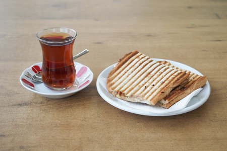 Traditional turkish tea and a sandwich on tableの写真素材