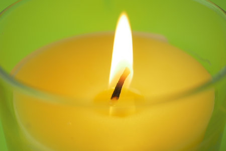 color candles slowly burning down in darkの写真素材