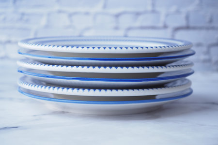 plates and napkin on wooden table .