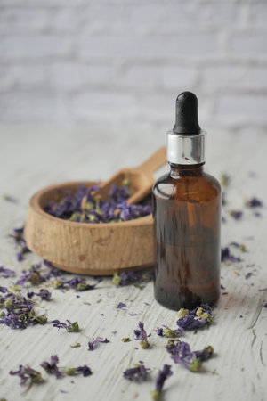 Essential lavender oil and flowers on table with copy spaceの写真素材