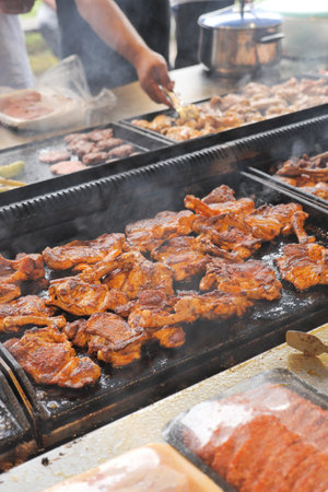 Beef and chicken steaks on the grill with flames.の写真素材