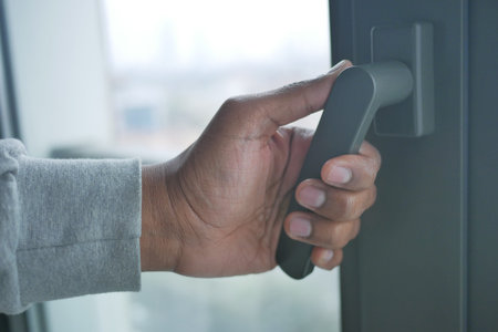 hand open gray plastic pvc window at home at early morning