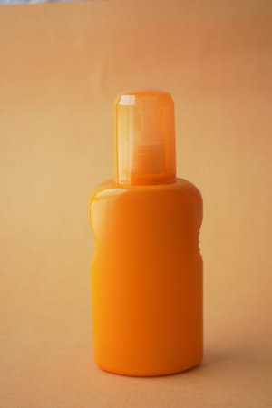 Close up of sunscreen cream ion orange color backgroundの写真素材
