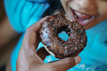the child is eating a donutの写真素材
