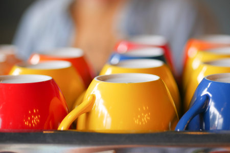 colorful coffee cup lined up on a coffee machine at cafe .