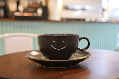 black coffee cup with smile shape design on itの写真素材