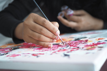 women hand holding brush with paint