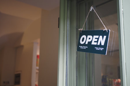 Open sign hanging front of cafe .の写真素材