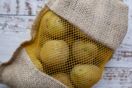 Close up of raw potatoes in a gunny bag on tableの写真素材