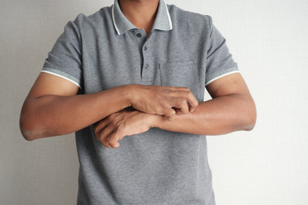 man suffering from itching skin, close up.の写真素材