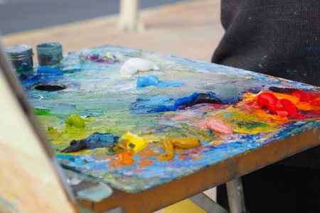 Colorful palette with oil painting and brushesの写真素材