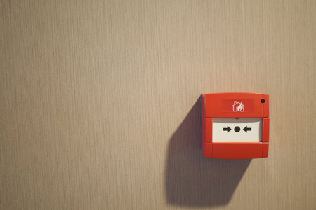 Red fire alarm button on wall ,