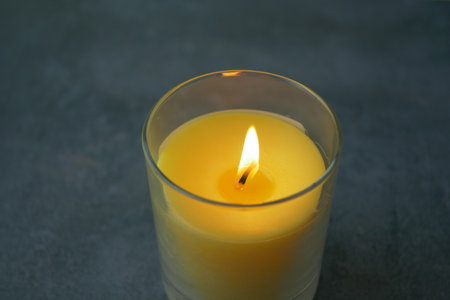 color candles slowly burning down in darkの写真素材