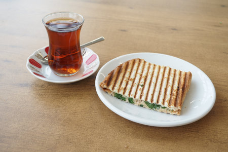 Traditional turkish tea and a sandwich on a tableの写真素材