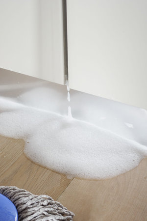 Spilled Water from a Dish Washer On Kitchen Floorの写真素材