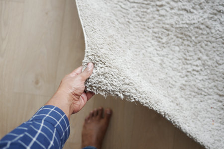 men hand rolling out new rug.の写真素材