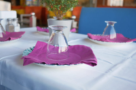 Empty plate, silverware and towel on table