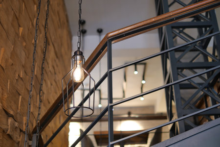 Burning stylish light bulbs at cafeの写真素材